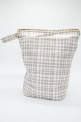 Large wet bag in print All Plaid out. Beautiful grey plaid, 2 pockets with gold zip detail. Flat bottom and handy domed handle.