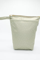 Large wet bag in print  Field of Hearts. Beautiful khaki background with tiny hearts scattered, 2 pockets with gold zip detail. Flat bottom and handy domed handle.