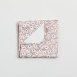 Reusable change mat in a soft lilac based daisy print. Luxe quilted finish with a soft bamboo terry, machine washable, perfectly paired with modern cloth nappies, bee details on snaps.