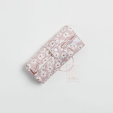 Reusable change mat in a soft lilac based daisy print. Luxe quilted finish with a soft bamboo terry, machine washable, perfectly paired with modern cloth nappies, bee details on snaps.