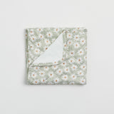 Reusable change mat in a soft sea mist green based daisy print. Luxe quilted finish with a soft bamboo terry, machine washable, perfectly paired with modern cloth nappies, bee details on snaps.