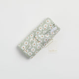 Reusable change mat in a soft sea mist green based daisy print. Luxe quilted finish with a soft bamboo terry, machine washable, perfectly paired with modern cloth nappies, bee details on snaps.