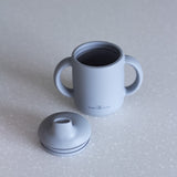 Silicone sippy cup in blue grey fog colour, double handle, photo shows the double ridge seal