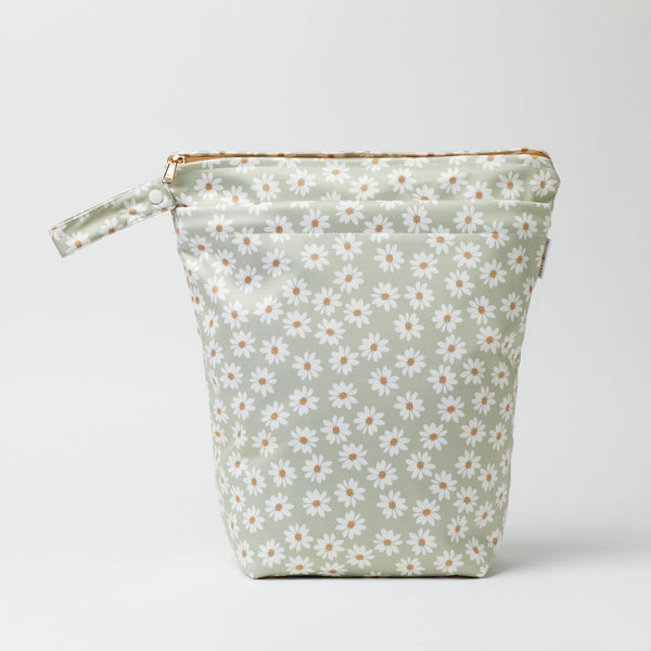 Large wet bag in print Wild Daisy sea mist, wild daisy print on a sea mist green background, 2 pockets with gold zip detail. Flat bottom and handy domed handle